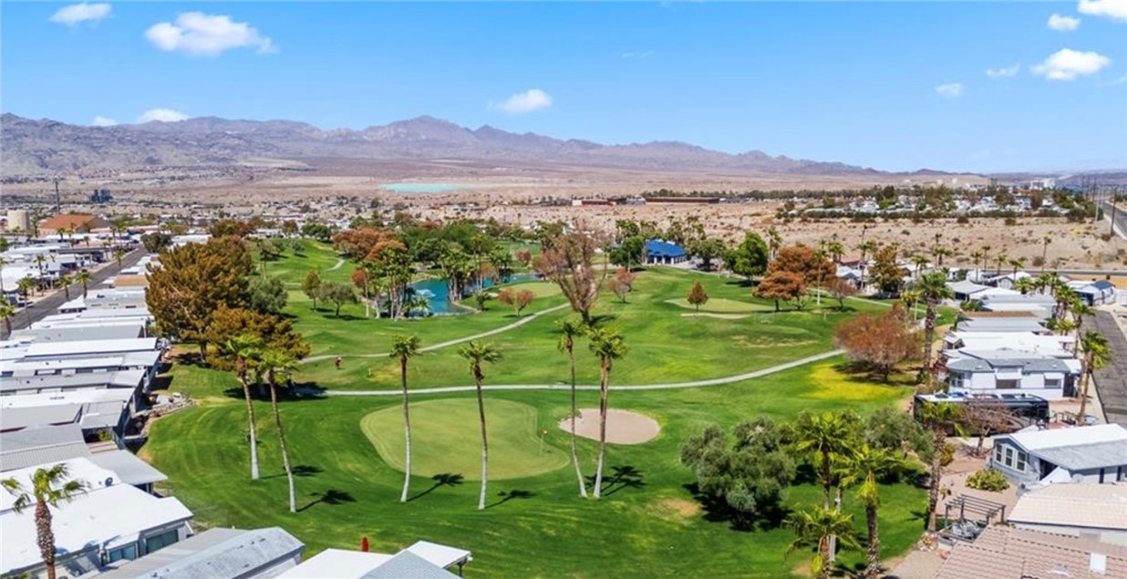 2000 Ramar Road, Unit 665 Bullhead City, AZ 86442 - Photo 63 of 83 Elevated view showcasing the golf course layout with mountain views and surrounding resort-style homes.