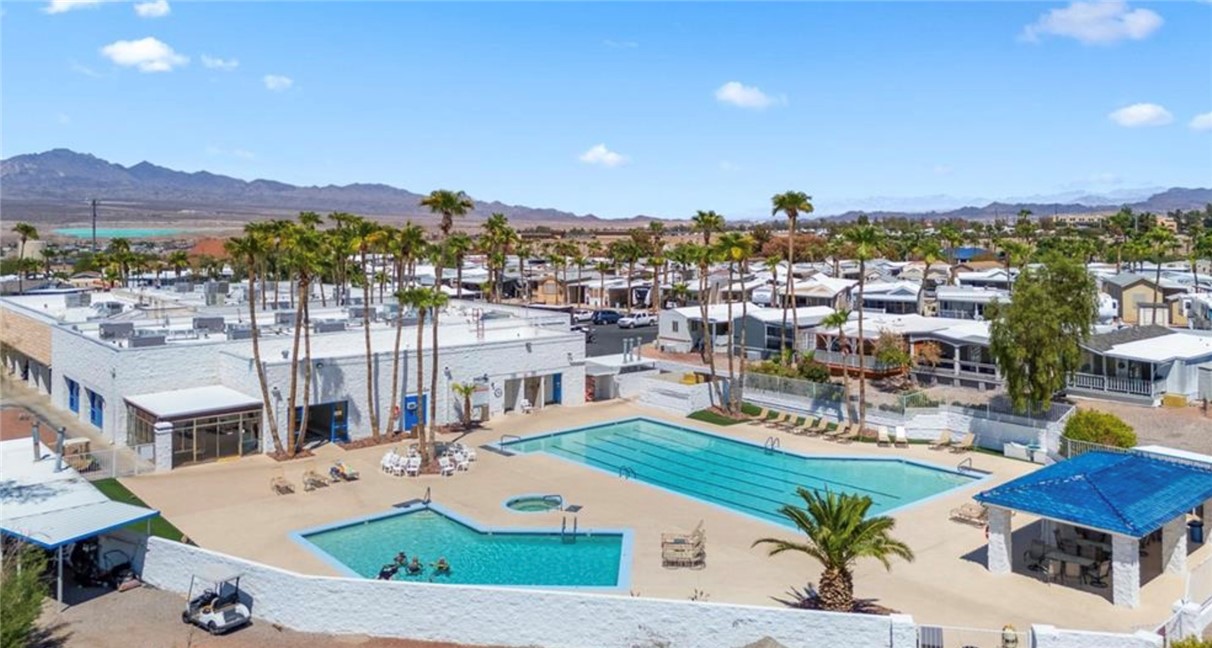 2000 Ramar Road, Unit 665 Bullhead City, AZ 86442 - Photo 64 of 83 Community swimming pool area with large pool, separate spa, and ample deck space for lounging.