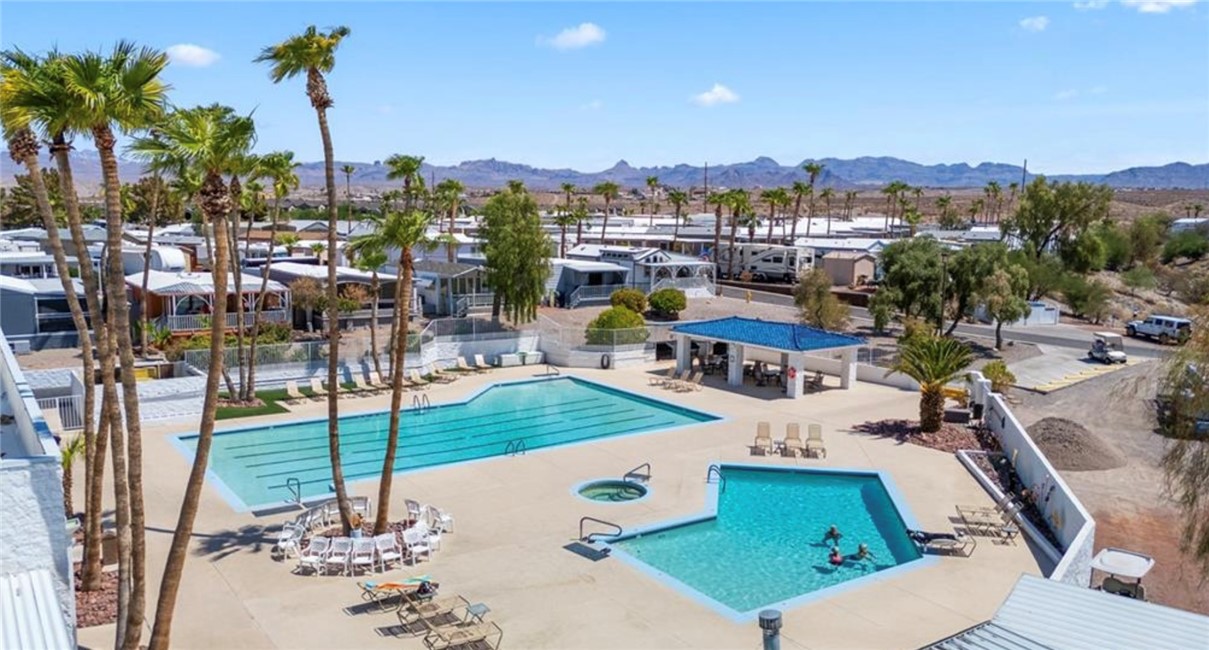 2000 Ramar Road, Unit 665 Bullhead City, AZ 86442 - Photo 65 of 83 Alternate view of the resort-style pool complex, featuring shaded seating and gathering areas.