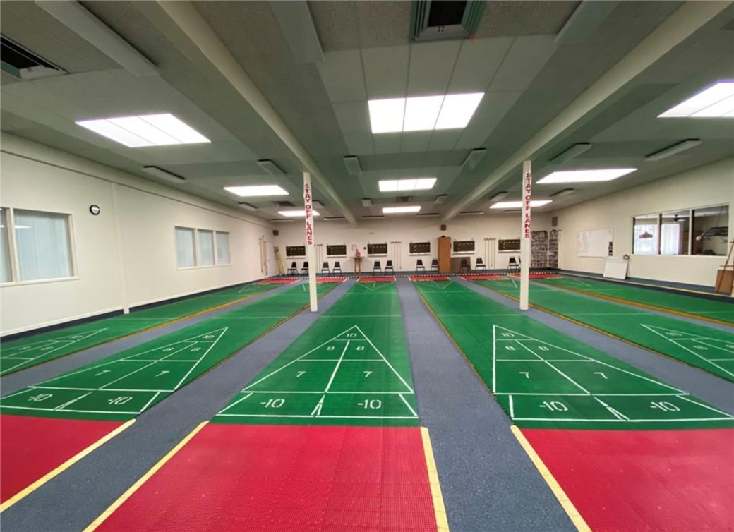 2000 Ramar Road, Unit 665 Bullhead City, AZ 86442 - Photo 73 of 83 Alternate view of the indoor shuffleboard hall, offering a climate-controlled space for year-round use.