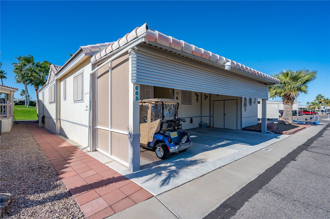 Wide covered carport with easy access ? perfect for everyday convenience and golf-cart livi