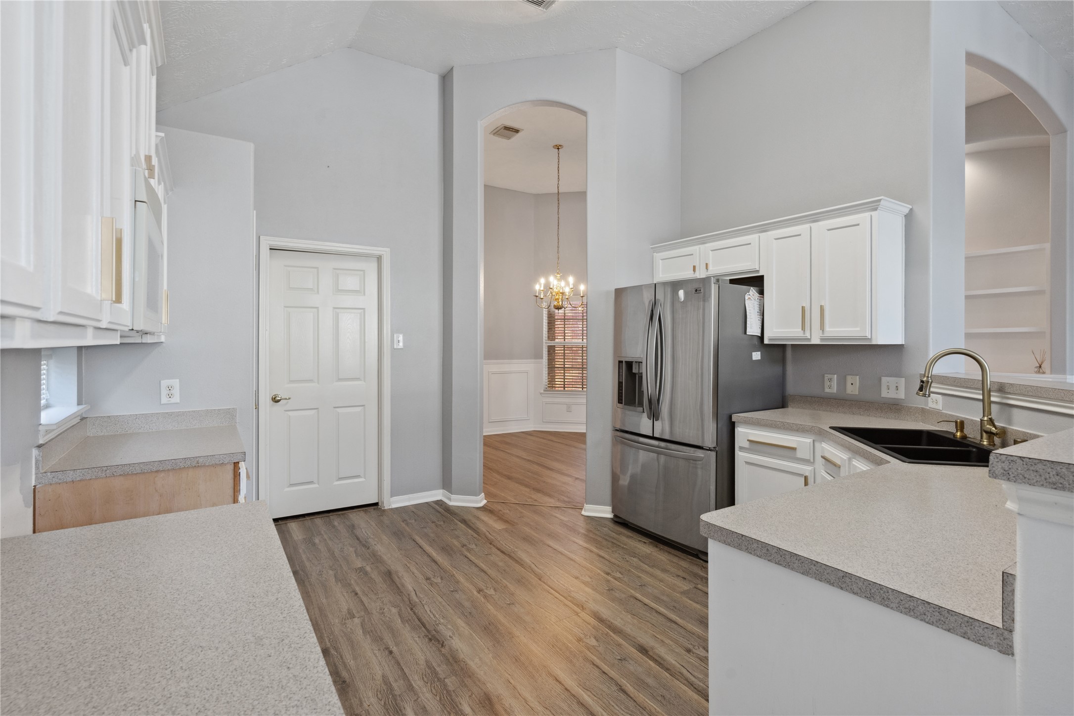 7906 Fortrose Court Houston, TX 77070 - Photo 14 of 28 a kitchen with a refrigerator cabinets and wooden floor