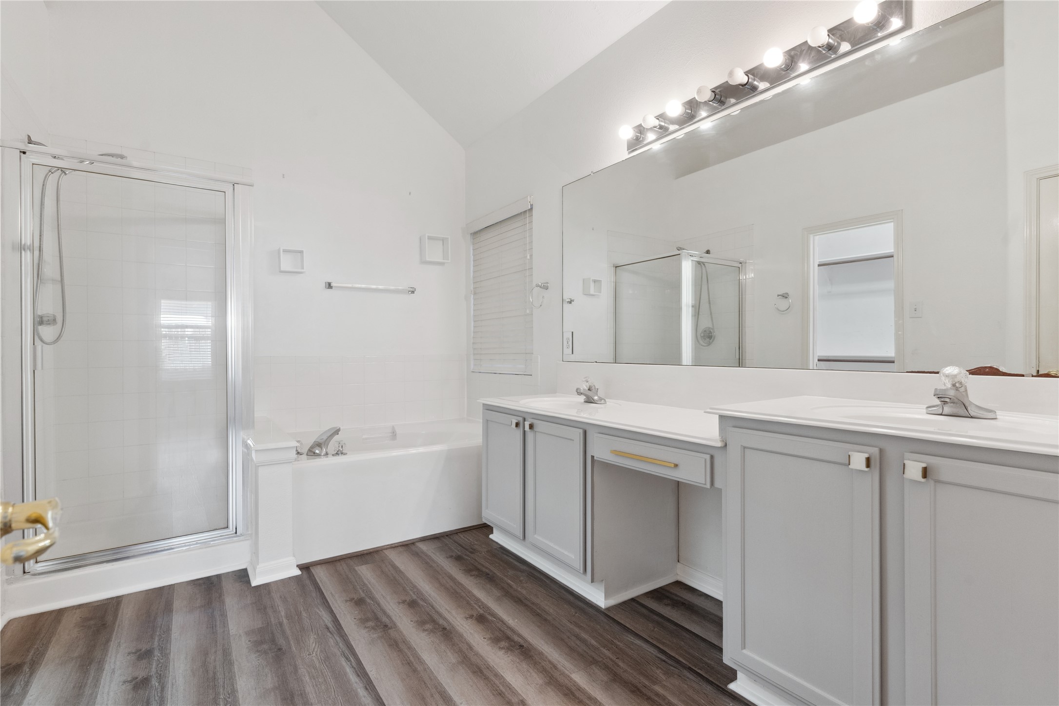 7906 Fortrose Court Houston, TX 77070 - Photo 19 of 28 a spacious bathroom with a double vanity sink a mirror and a bathtub