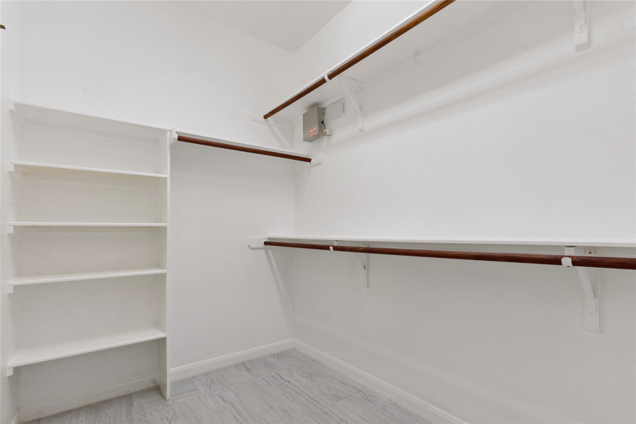 7906 Fortrose Court Houston, TX 77070 - Photo 22 of 28 a view of walk in closet with empty racks