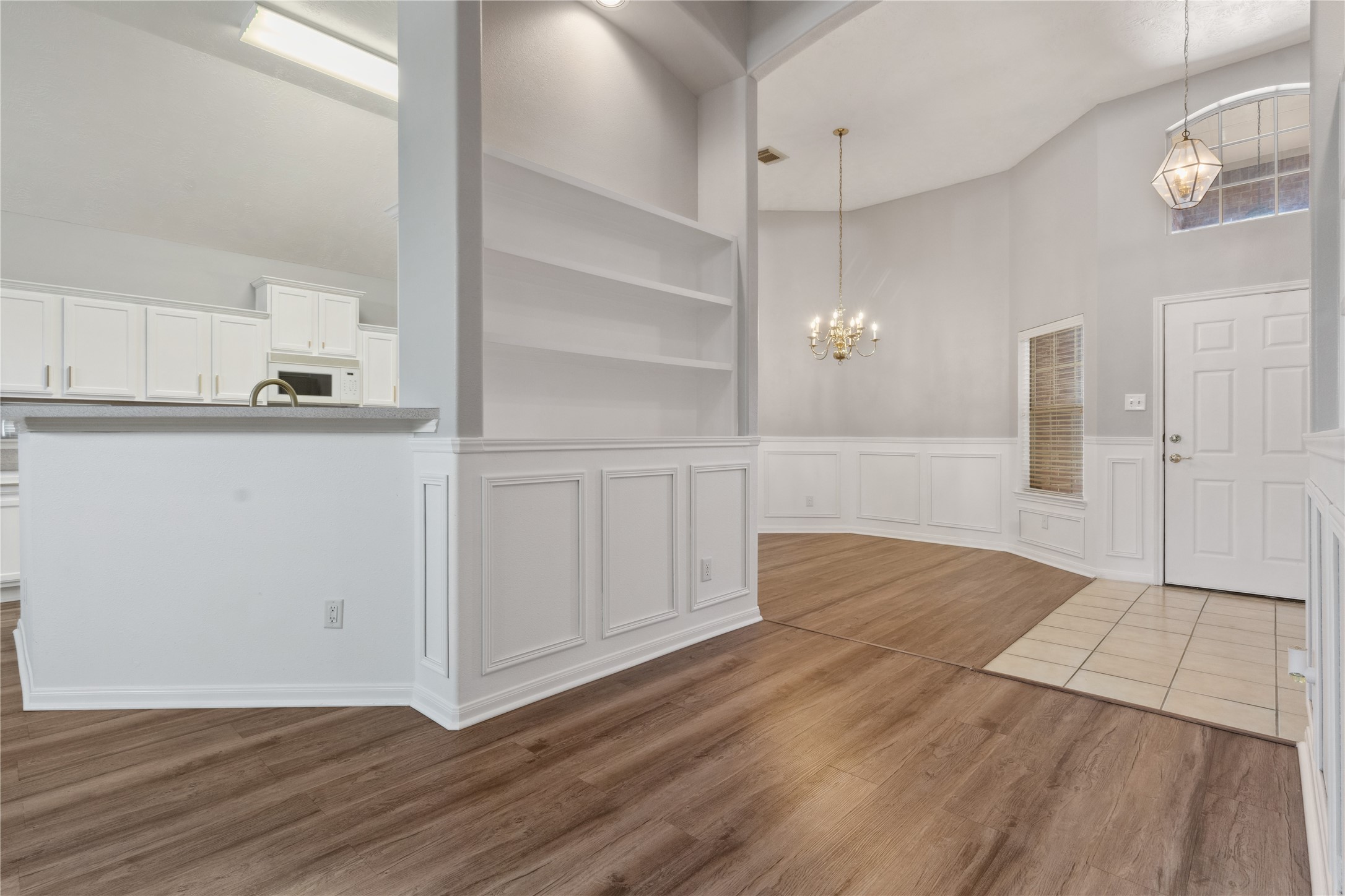 7906 Fortrose Court Houston, TX 77070 - Photo 6 of 28 a view of a kitchen with wooden floor and cabinets