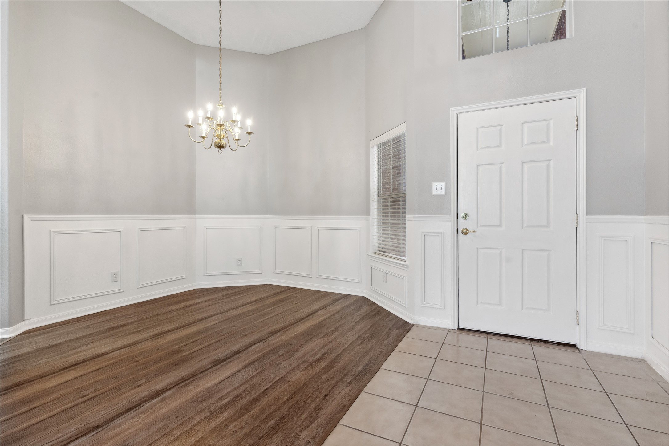 7906 Fortrose Court Houston, TX 77070 - Photo 7 of 28 a view of empty room with wooden floor and chandelier