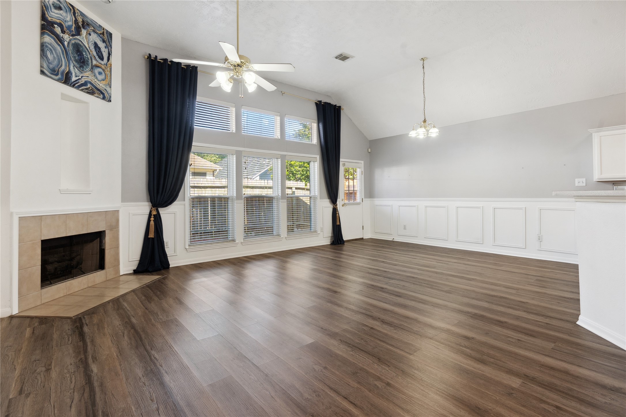 7906 Fortrose Court Houston, TX 77070 - Photo 8 of 28 a view of a livingroom with wooden floor a fireplace and window