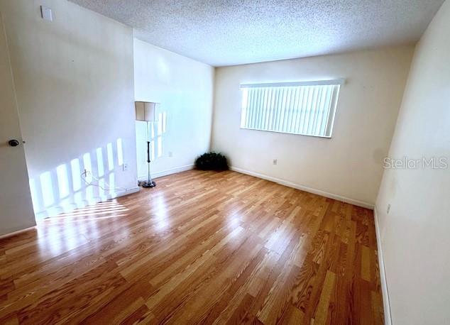 946 Virginia Street, Unit 104 Dunedin, FL 34698 - Photo 11 of 64 a view of an empty room and wooden floor