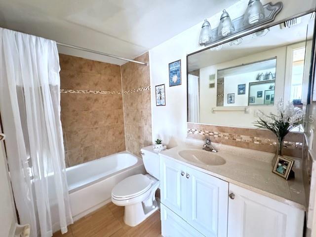 946 Virginia Street, Unit 104 Dunedin, FL 34698 - Photo 13 of 64 a bathroom with a sink a toilet and shower