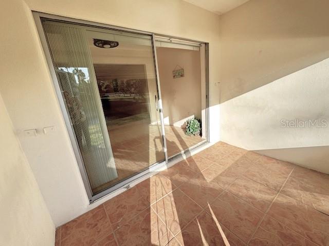 946 Virginia Street, Unit 104 Dunedin, FL 34698 - Photo 16 of 64 a bedroom with a bed and a mirror