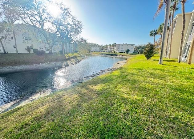 946 Virginia Street, Unit 104 Dunedin, FL 34698 - Photo 18 of 64 a view of a lake with houses