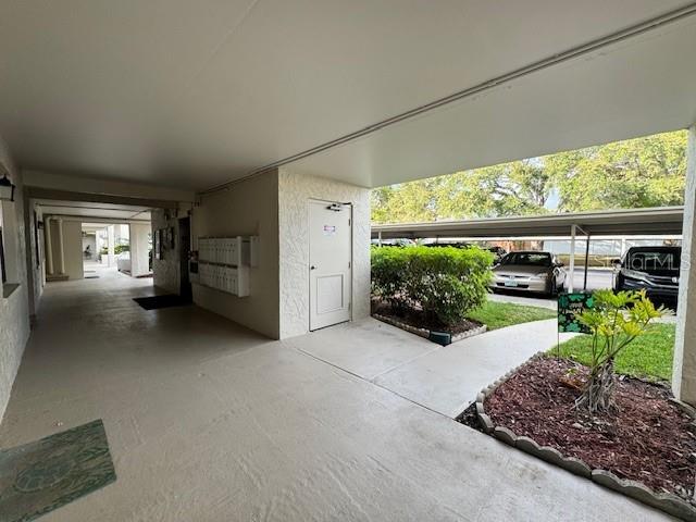946 Virginia Street, Unit 104 Dunedin, FL 34698 - Photo 20 of 64 a view of a porch with furniture and a garden