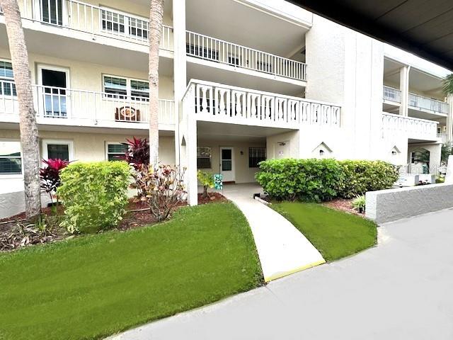 946 Virginia Street, Unit 104 Dunedin, FL 34698 - Photo 2 of 64 a view of a house with a yard