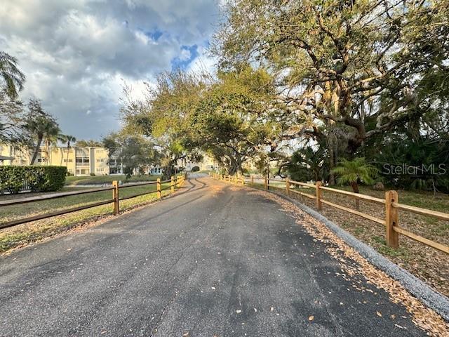 946 Virginia Street, Unit 104 Dunedin, FL 34698 - Photo 23 of 64 a view of a road with a yard