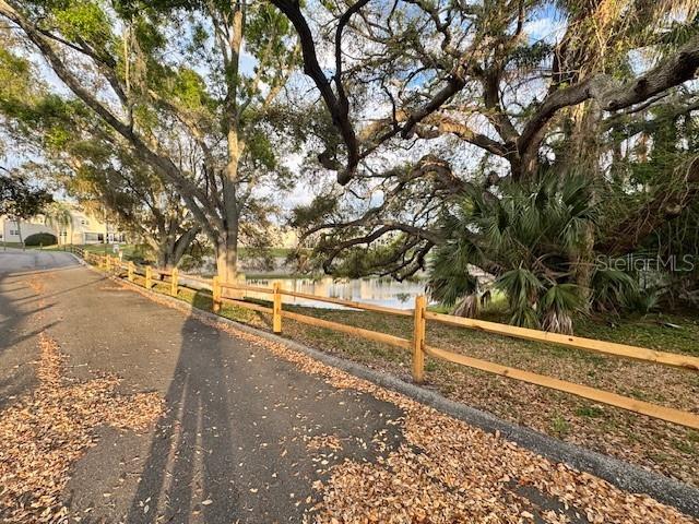 946 Virginia Street, Unit 104 Dunedin, FL 34698 - Photo 25 of 64 a view of a yard with wooden fence