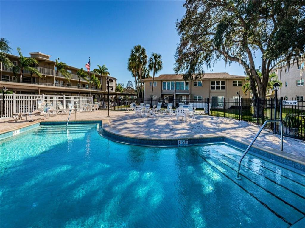 946 Virginia Street, Unit 104 Dunedin, FL 34698 - Photo 30 of 64 a view of a house with swimming pool and sitting area