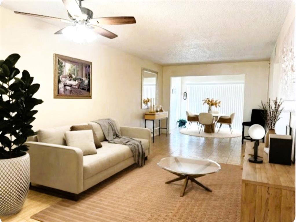 946 Virginia Street, Unit 104 Dunedin, FL 34698 - Photo 3 of 64 a living room with furniture and a large window