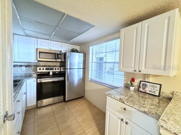 946 Virginia Street, Unit 104 Dunedin, FL 34698 - Photo 6 of 64 a kitchen with stainless steel appliances granite countertop a stove a sink and a microwave