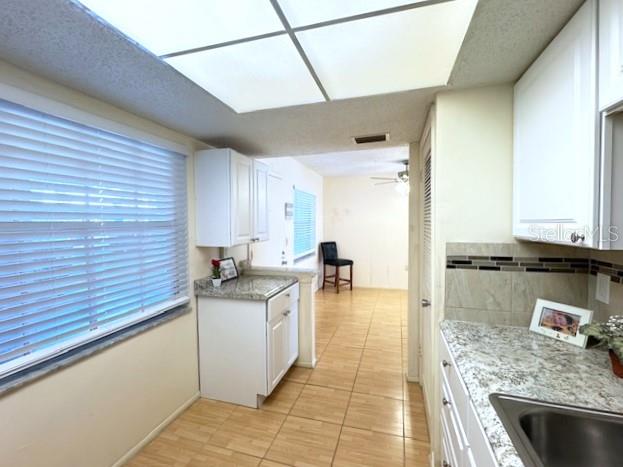 946 Virginia Street, Unit 104 Dunedin, FL 34698 - Photo 7 of 64 a kitchen with stainless steel appliances granite countertop a sink stove and cabinets