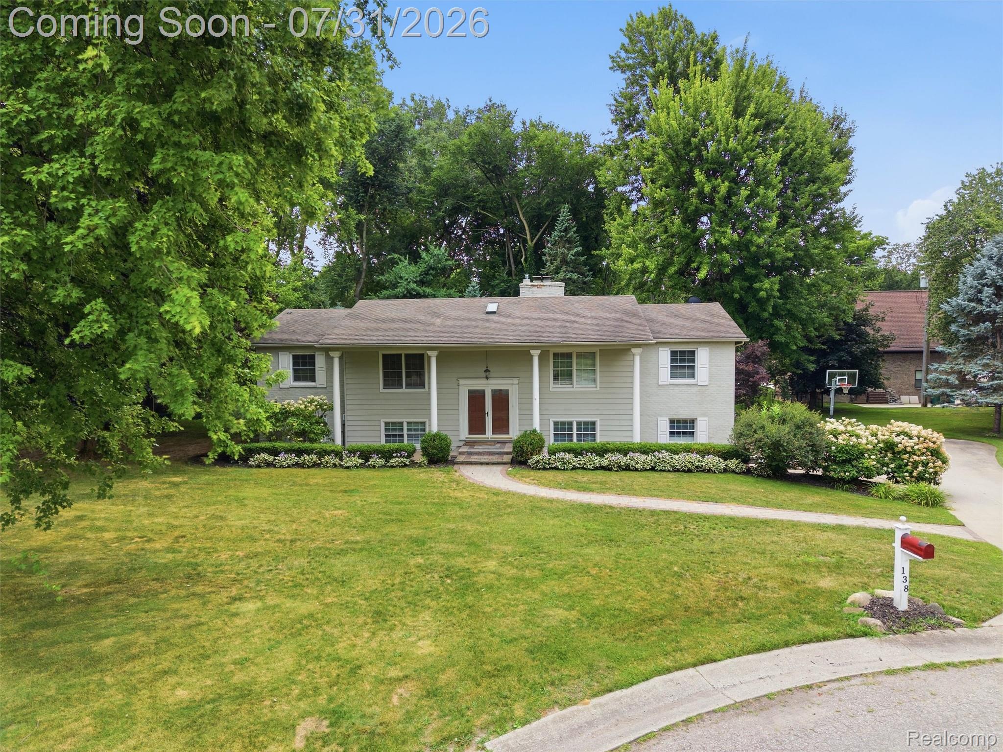 138 Aintree Road Rochester, MI 48306 - Photo 6 of 53 Split-level residence featuring a light-colored exterior, white trim, and a prominent front entrance with double red doors