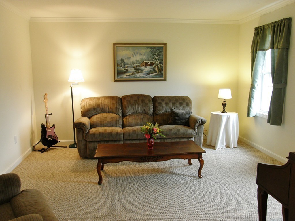 12 Tannery Road Sturbridge, MA 01518 - Photo 13 of 26 a living room with furniture and a lamp