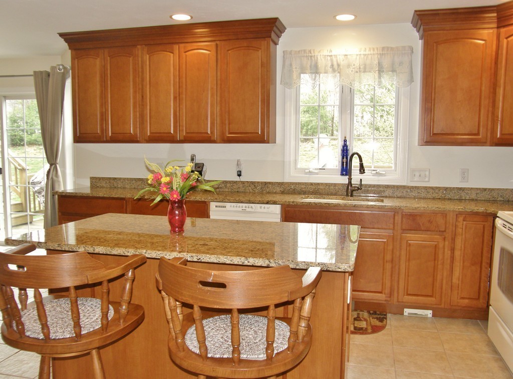 12 Tannery Road Sturbridge, MA 01518 - Photo 3 of 26 a kitchen with a dining table chairs and chandelier