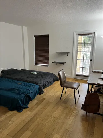 a bed room with a bed and a chair