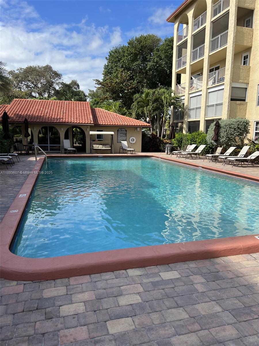 950 Ponce De Leon Road, Unit 2100 Boca Raton, FL 33432 - Photo 6 of 15 a view of a swimming pool and deck