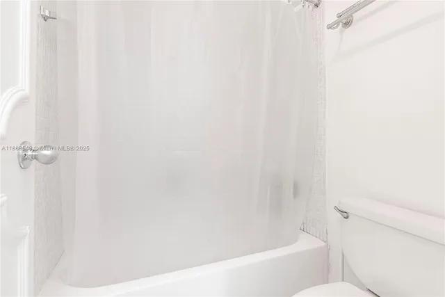 a bathroom with a bathtub and a toilet