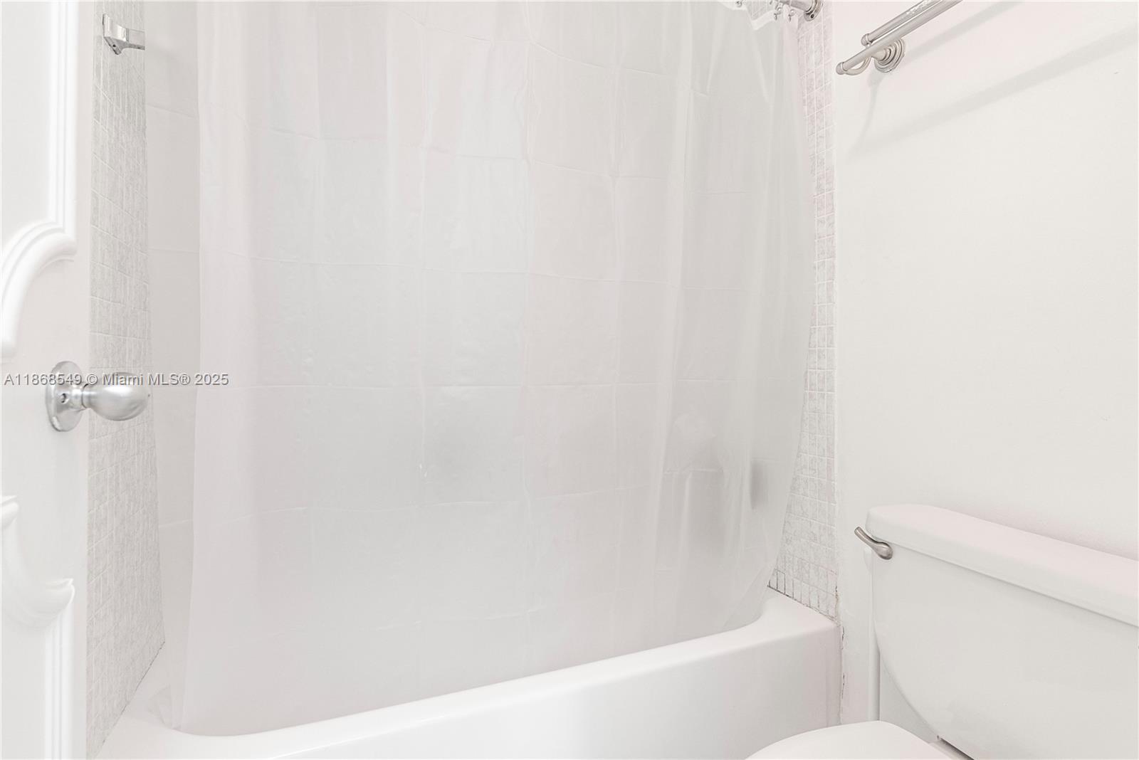 5701 Collins Avenue, Unit 405 Miami Beach, FL 33140 - Photo 12 of 18 a bathroom with a bathtub and a toilet
