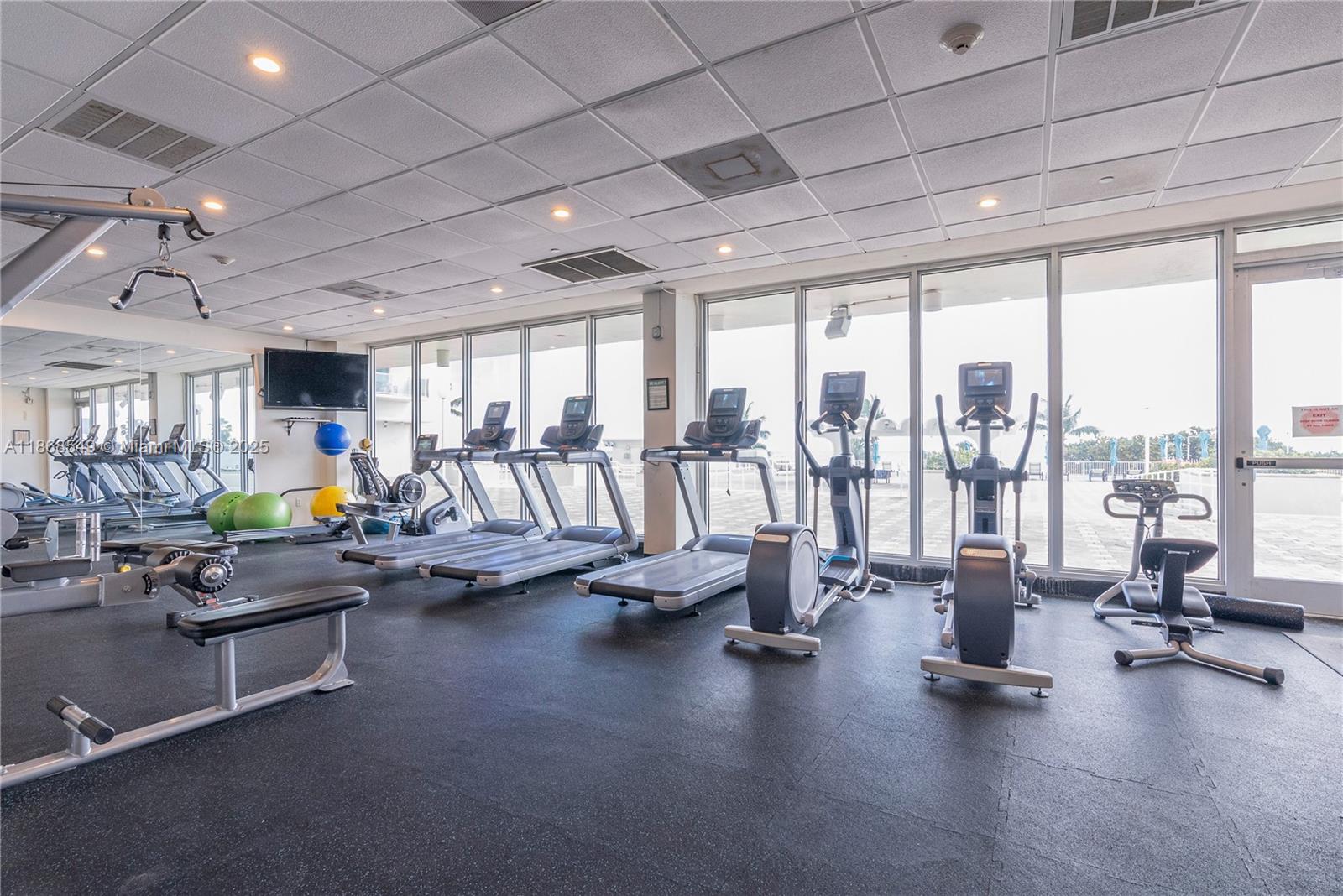 5701 Collins Avenue, Unit 405 Miami Beach, FL 33140 - Photo 14 of 18 a view of a room with gym equipment