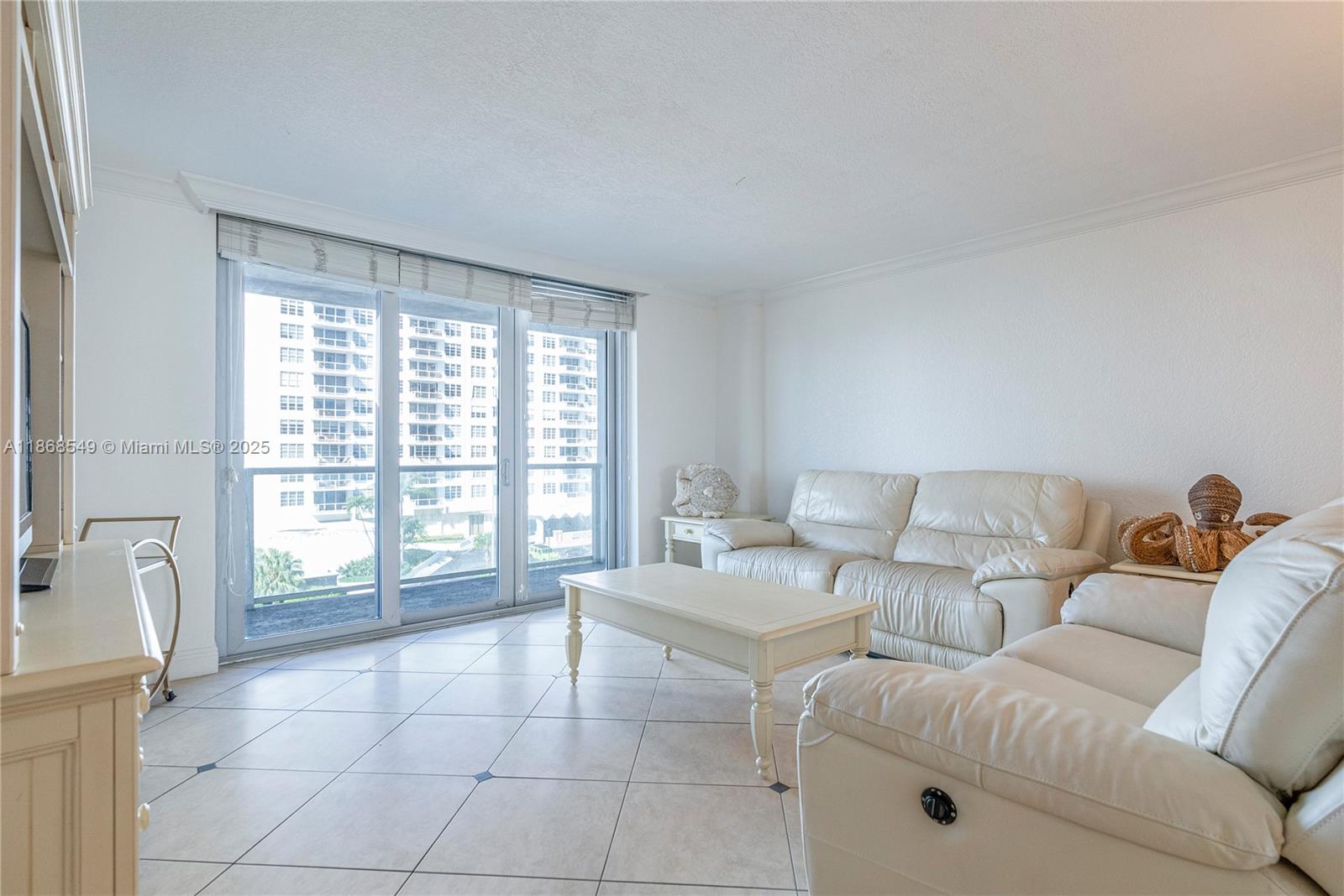 5701 Collins Avenue, Unit 405 Miami Beach, FL 33140 - Photo 2 of 18 a living room with furniture and a large window