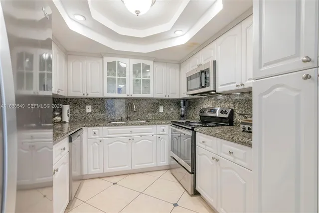a kitchen with stainless steel appliances granite countertop a sink and cabinets