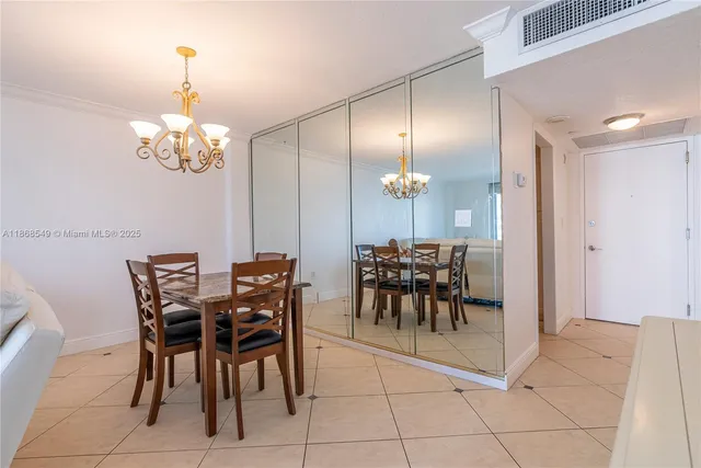 a view of a dining room with furniture and chandelier