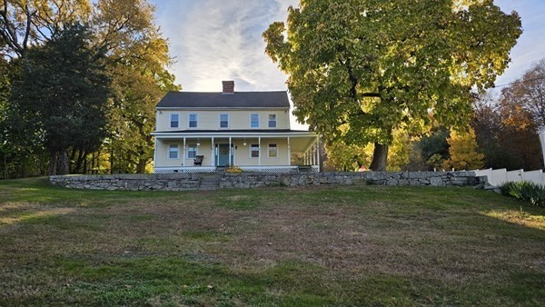 95 Providence Street, Unit B Mendon, MA 01756 - Photo 11 of 17 a view of a yard in front of a house with large trees