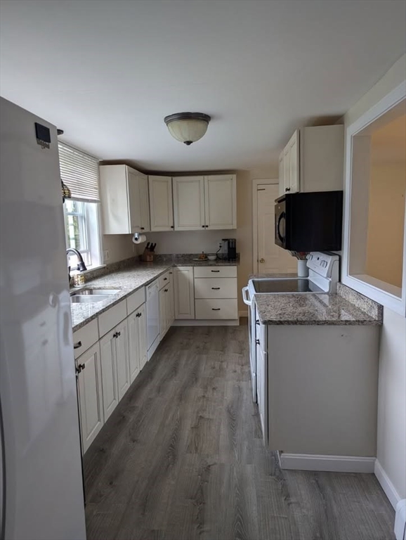 95 Providence Street, Unit B Mendon, MA 01756 - Photo 2 of 17 a kitchen with granite countertop cabinets stainless steel appliances a sink and a window