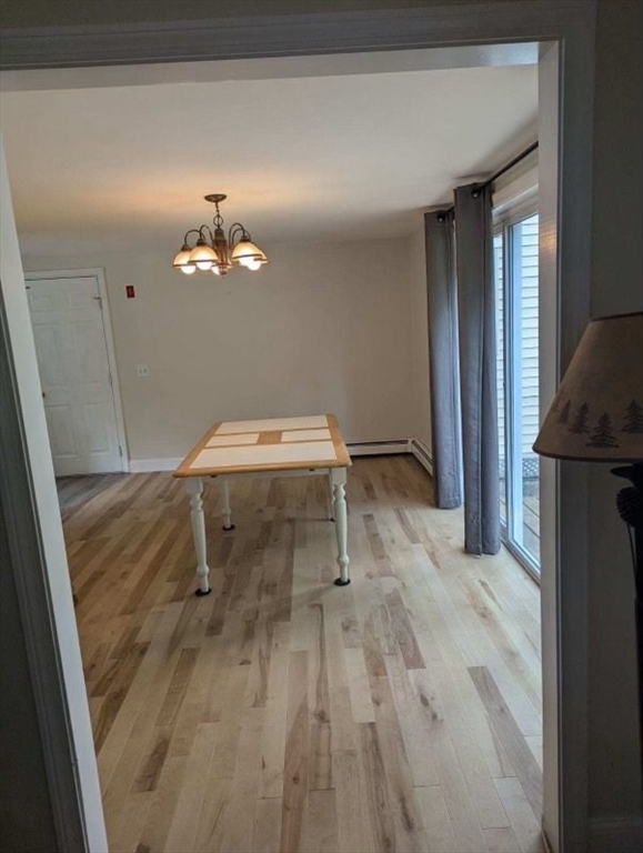 95 Providence Street, Unit B Mendon, MA 01756 - Photo 3 of 17 a room with a table and chairs