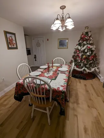 a view of a dining room with furniture and chandelier