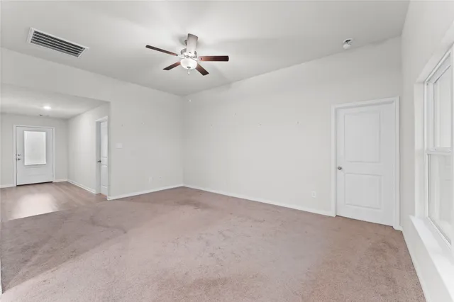 a view of an empty room with a window