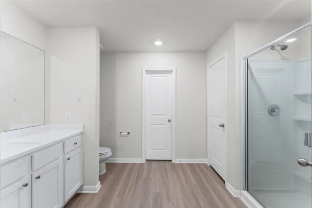 a bathroom with a glass shower door