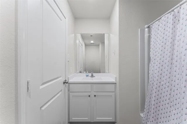 a bathroom with a sink and vanity