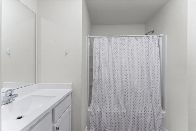 an empty room with wooden floor and window