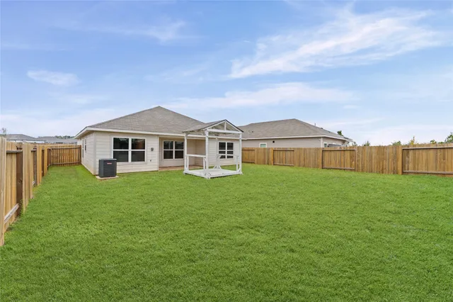 a view of a backyard with a garden and entertaining space