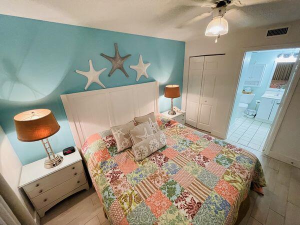 1002 Highway 98, Unit 505 Destin, FL 32541 - Photo 11 of 17 a bedroom with a bed and dresser