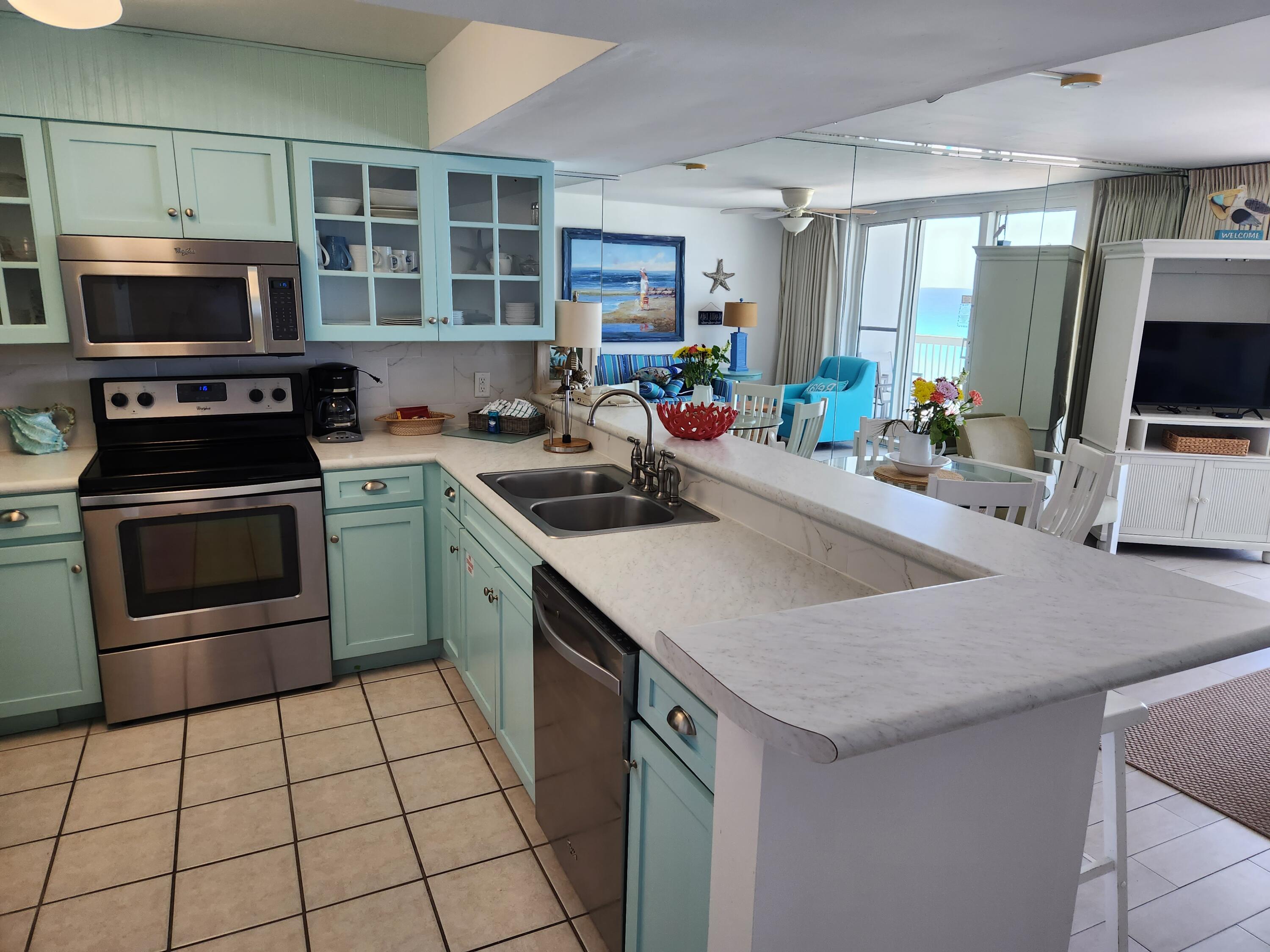 1002 Highway 98, Unit 505 Destin, FL 32541 - Photo 6 of 17 a kitchen with a sink a stove and cabinets