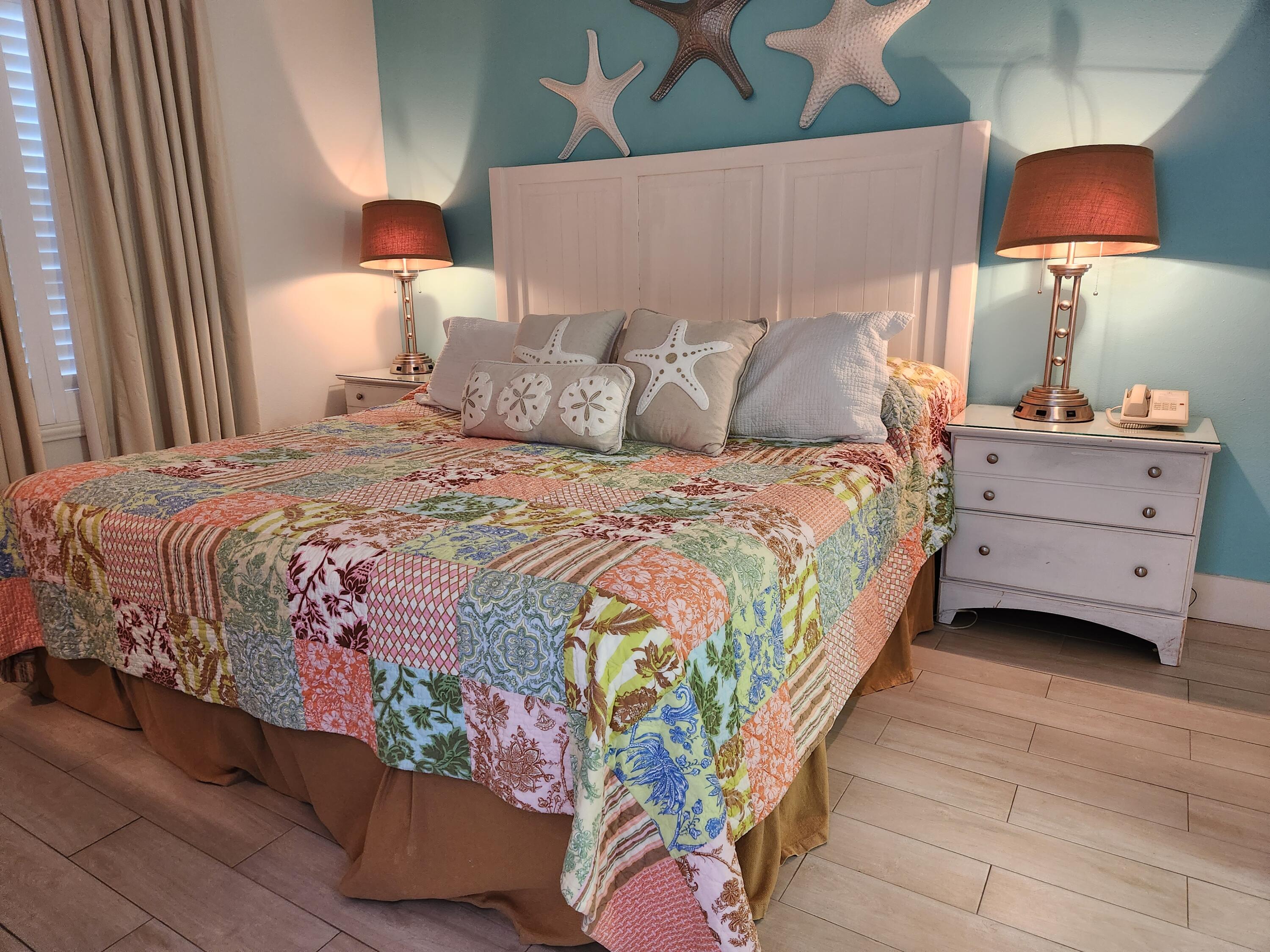 1002 Highway 98, Unit 505 Destin, FL 32541 - Photo 9 of 17 a bedroom with a bed and a lamp