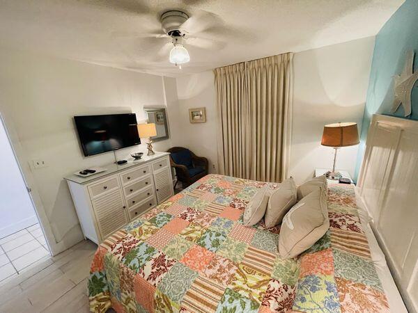 1002 Highway 98, Unit 505 Destin, FL 32541 - Photo 10 of 17 a bedroom with furniture and a flat screen tv