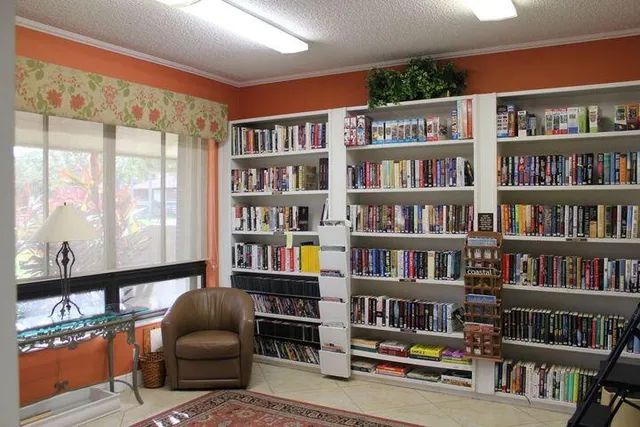 a living room with furniture cabinets and book shelf