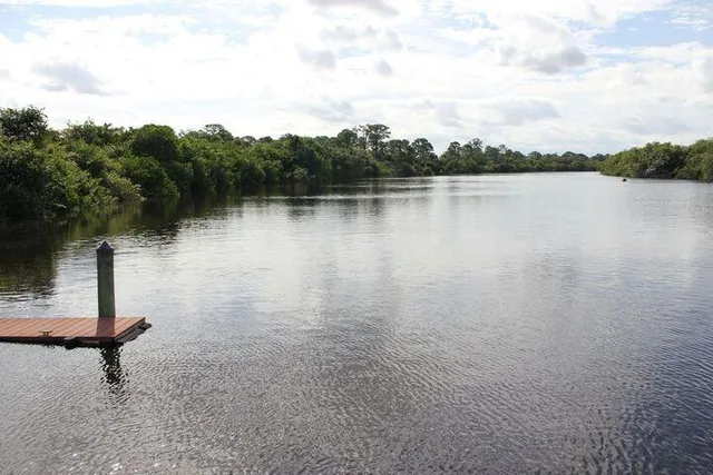 a view of residential houses with outdoor space and lake view