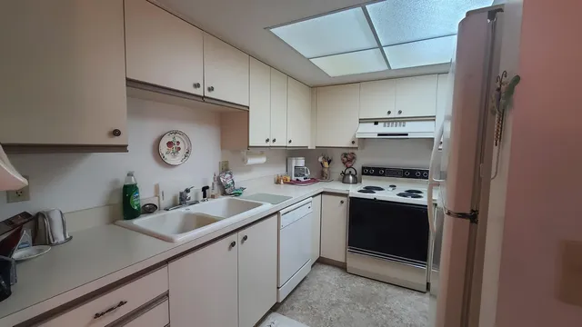 a kitchen with sink and cabinets